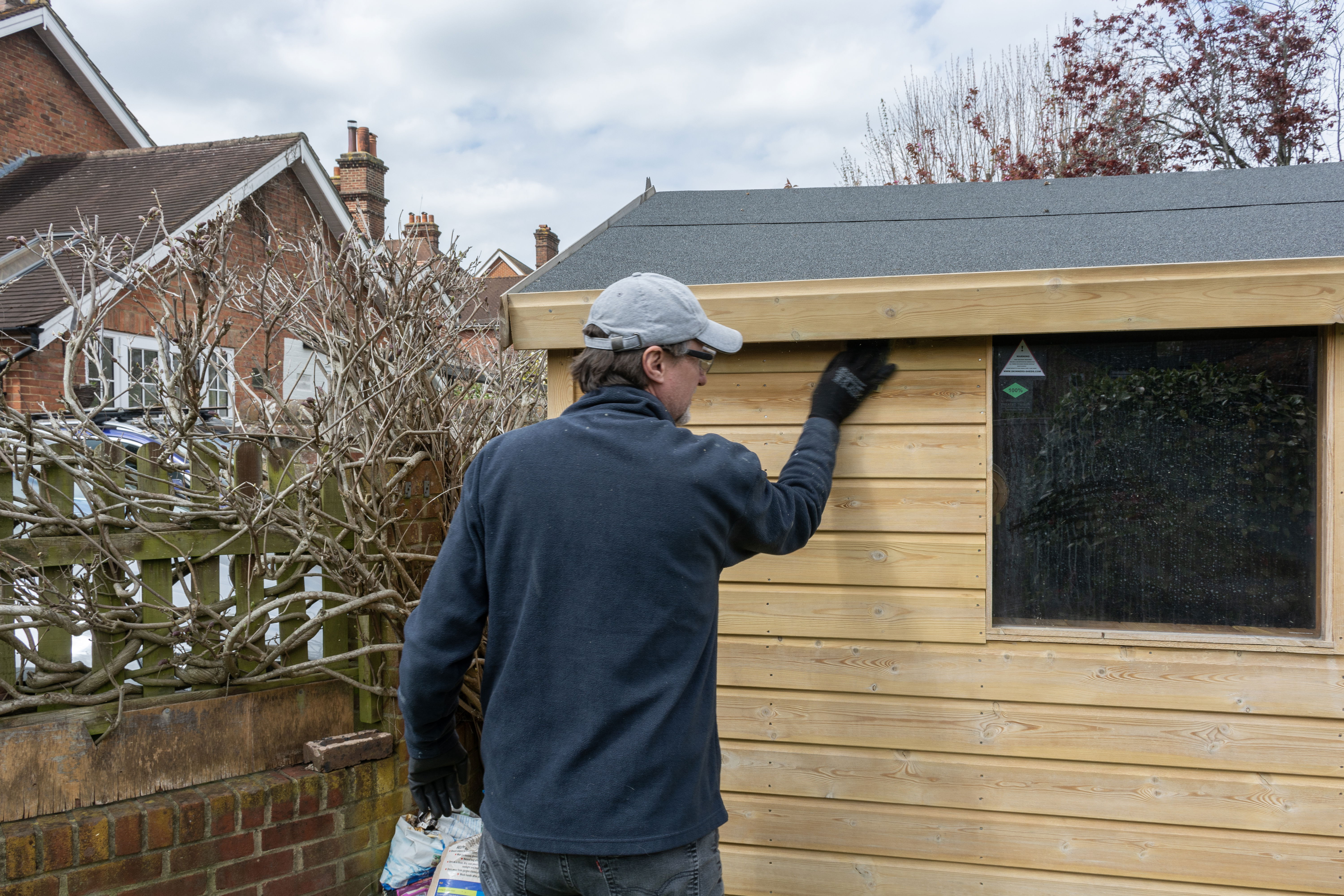 A contractor cleans a shed.