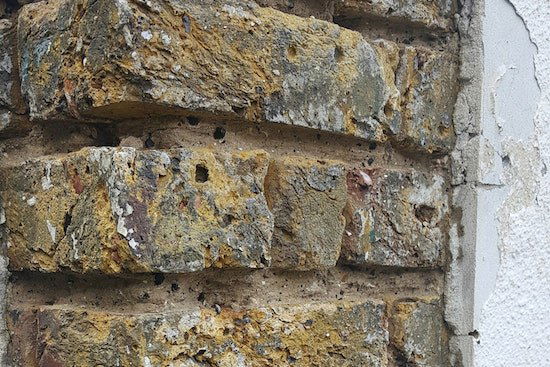 Concrete render being remove from the wall.