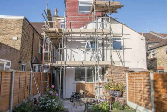 A house with scaffolding against the building's facade.