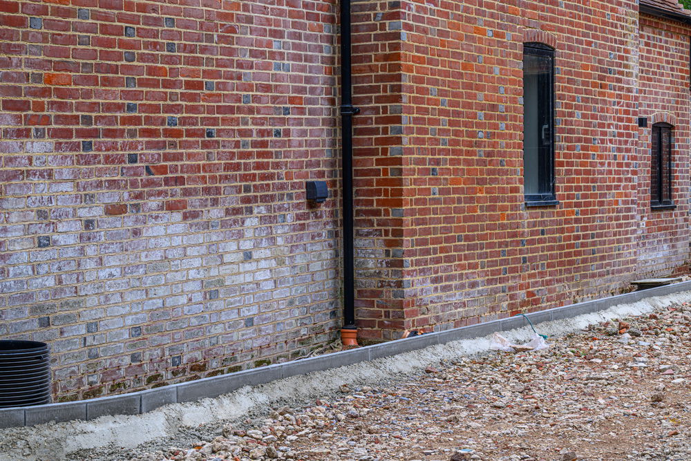 The Old Mill exterior efflorescent salts on wall - Photograph by Paul French