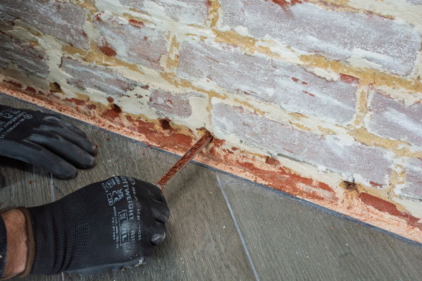 Detail on the Dryzone Hole-Clearing Tool prior to Dryzone DPC Cream.