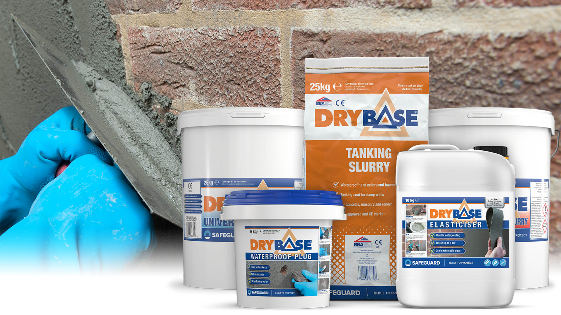 The Drybase Tanking Range in front of gloved hand applying tanking slurry to a brick wall.