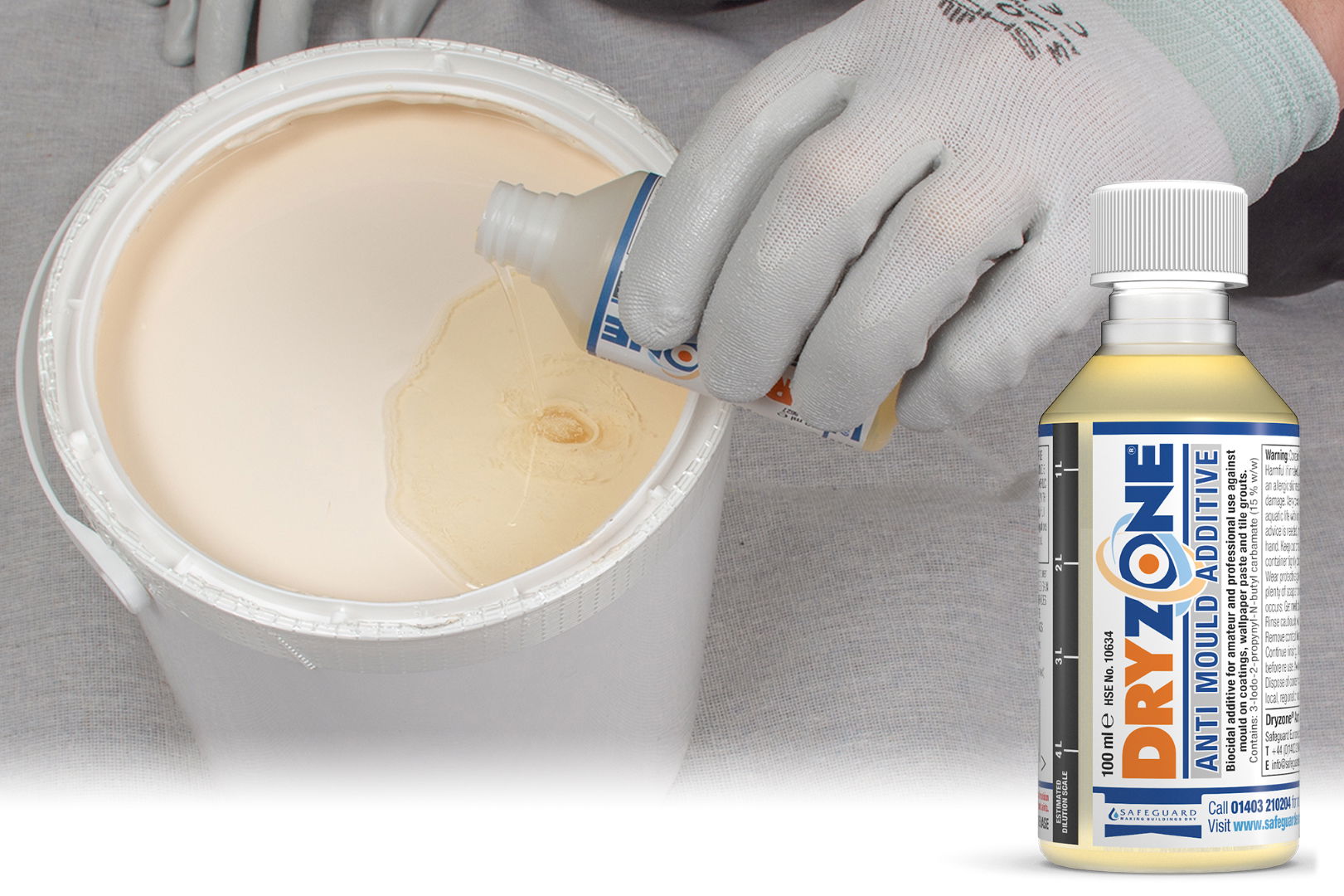 A gloved hand pours Dryzone Anti-Mould Additive into a paint pot.