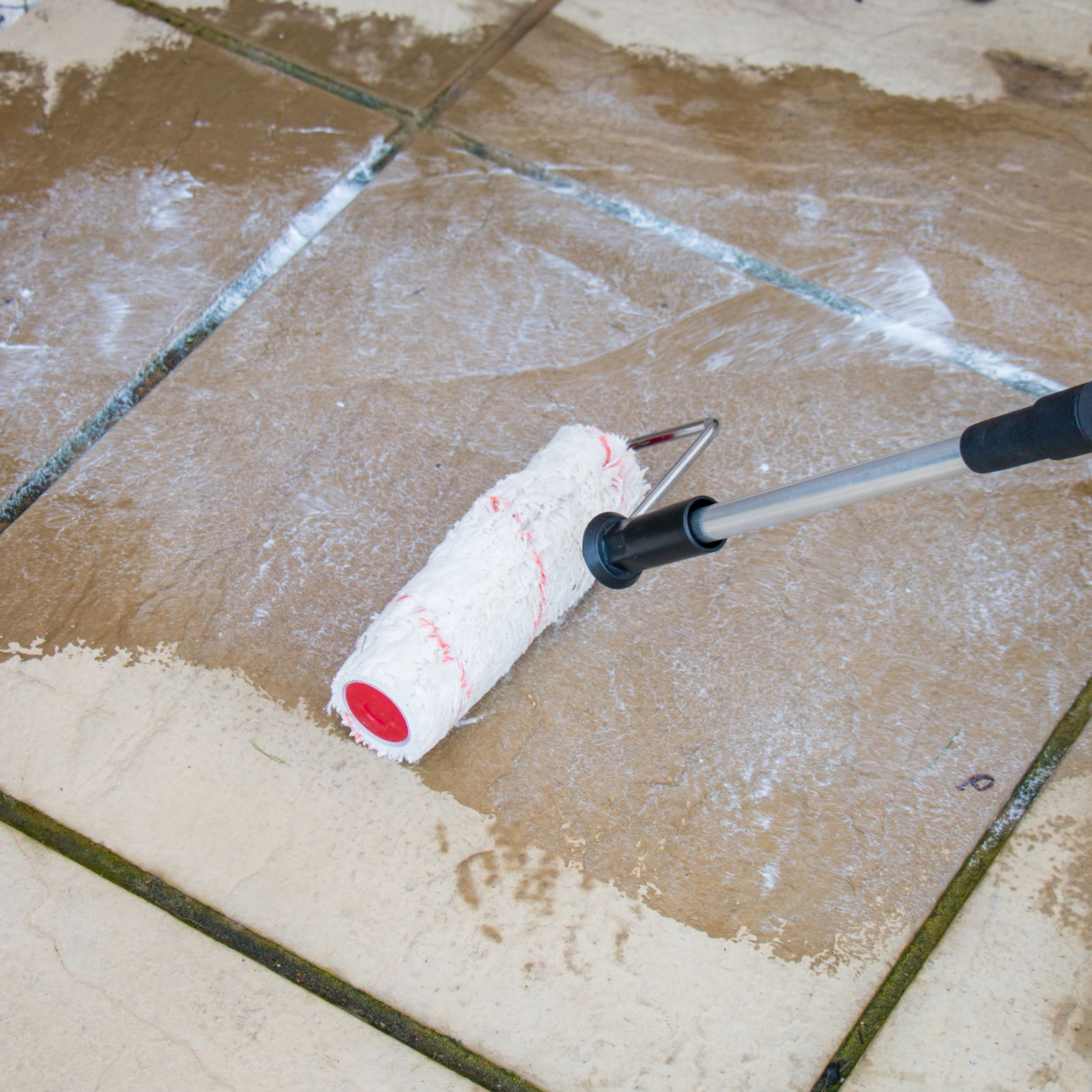 Using a roller to apply Roxil Patio Cream